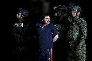 Joaquin &quot;El Chapo&quot; Guzman is escorted by soldiers during a presentation at the hangar belonging to the office of the Attorney General in Mexico City, Mexico January 8, 2016.  REUTERS/Edgard Garrido