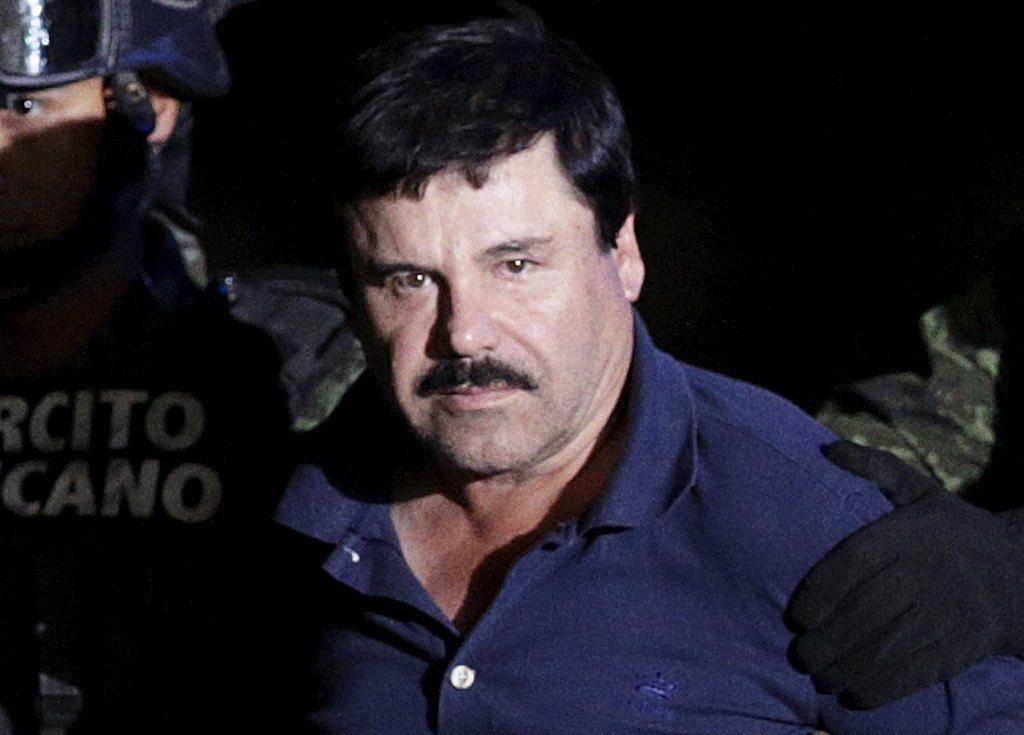 Recaptured drug lord Joaquin &quot;El Chapo&quot; Guzman is escorted by soldiers at the hangar belonging to the office of the Attorney General in Mexico City, Mexico January 8, 2016. Picture taken January 8, 2016. REUTERS/Henry Romero