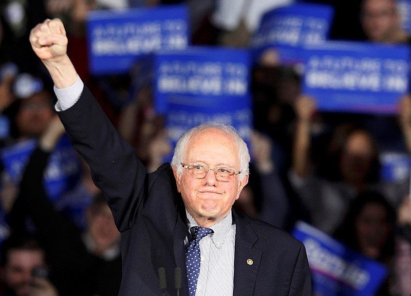 Bernie Sanders raises a fist as he speaks at his caucus night rally Des Moines. REUTERS/Rick Wilking