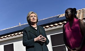U.S. Democratic presidential candidate Hillary Clinton (L) meets with homeowner Vicki Early to discuss her solar panels in Las Vegas, Nevada February 19, 2016. REUTERS/David Becker/File Photo