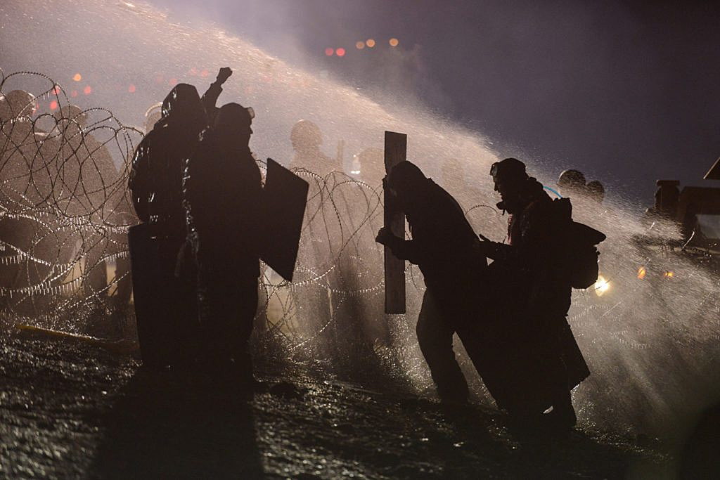 Police use a water cannon on protesters during a protest near the Standing Rock Indian Reservation. REUTERS/Stephanie Keith